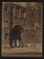 Photograph of an unidentified trio [J. J. Thomson, F. W. Aston, and E. D. Adrian?] in the archway of King Edward's Gate, Trinity College